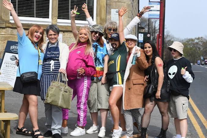 Friends with coloured hair and costumes on the crawl